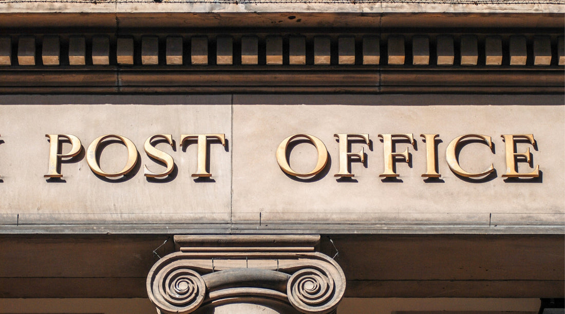 a close up of the post office sign