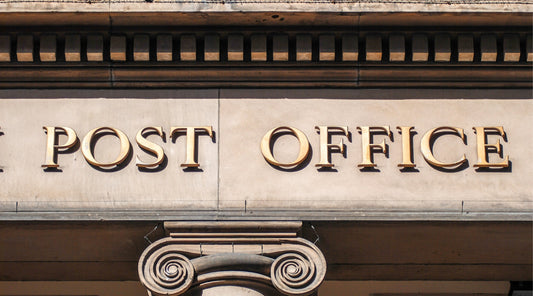 a close up of the post office sign