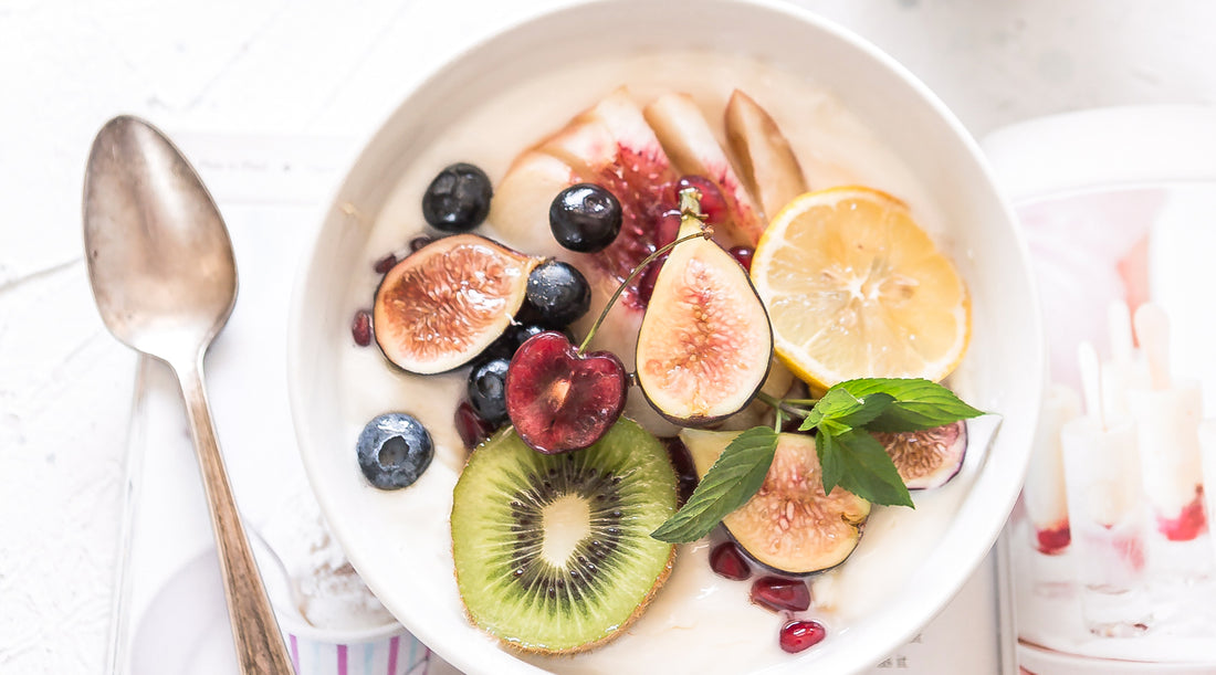 A bowl of oatmeal topped with a medley of colorful fruits. It is paired with a blog "What Is the Human Mycobiome?". 