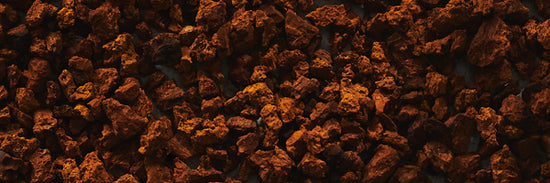 Chaga chunk or nugget texture in orange and dark brown colours. 