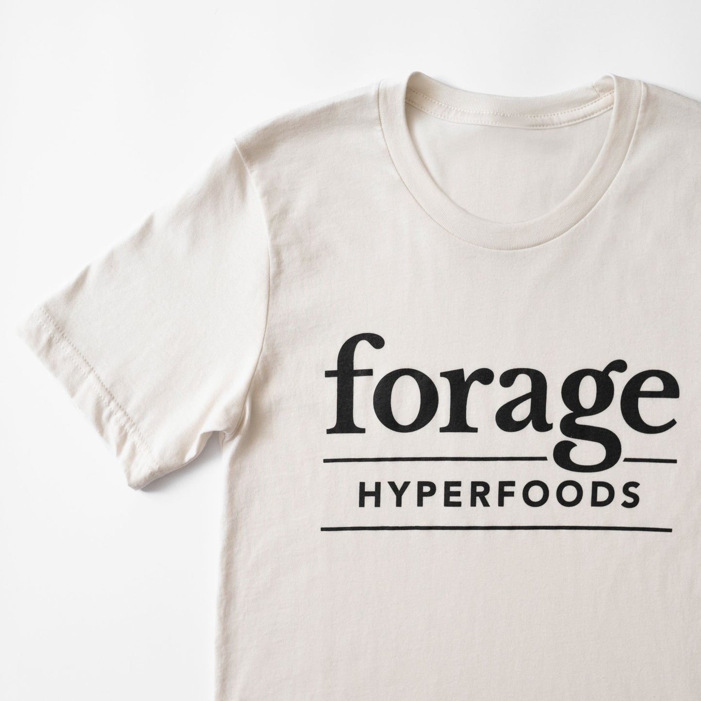 A vintage white shirt with the Forage Logo on the front.