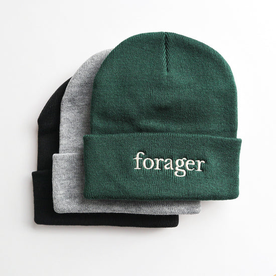 Three beanie/toque hats with the word 