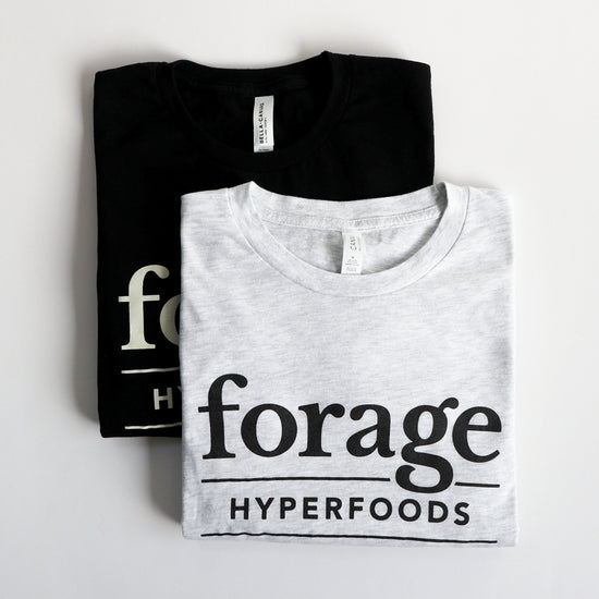 Two Forage Hyperfoods long-sleeved tee shirts. The gray one with black text is in the forefront and says 