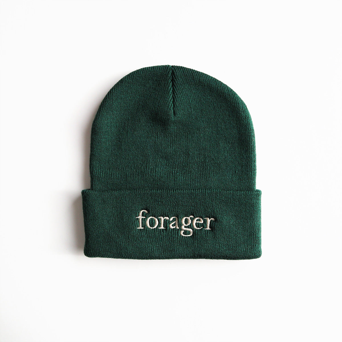 A green beanie with the word "forager" on it. 