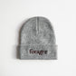 A gray beanie with the word "forager" on it. 
